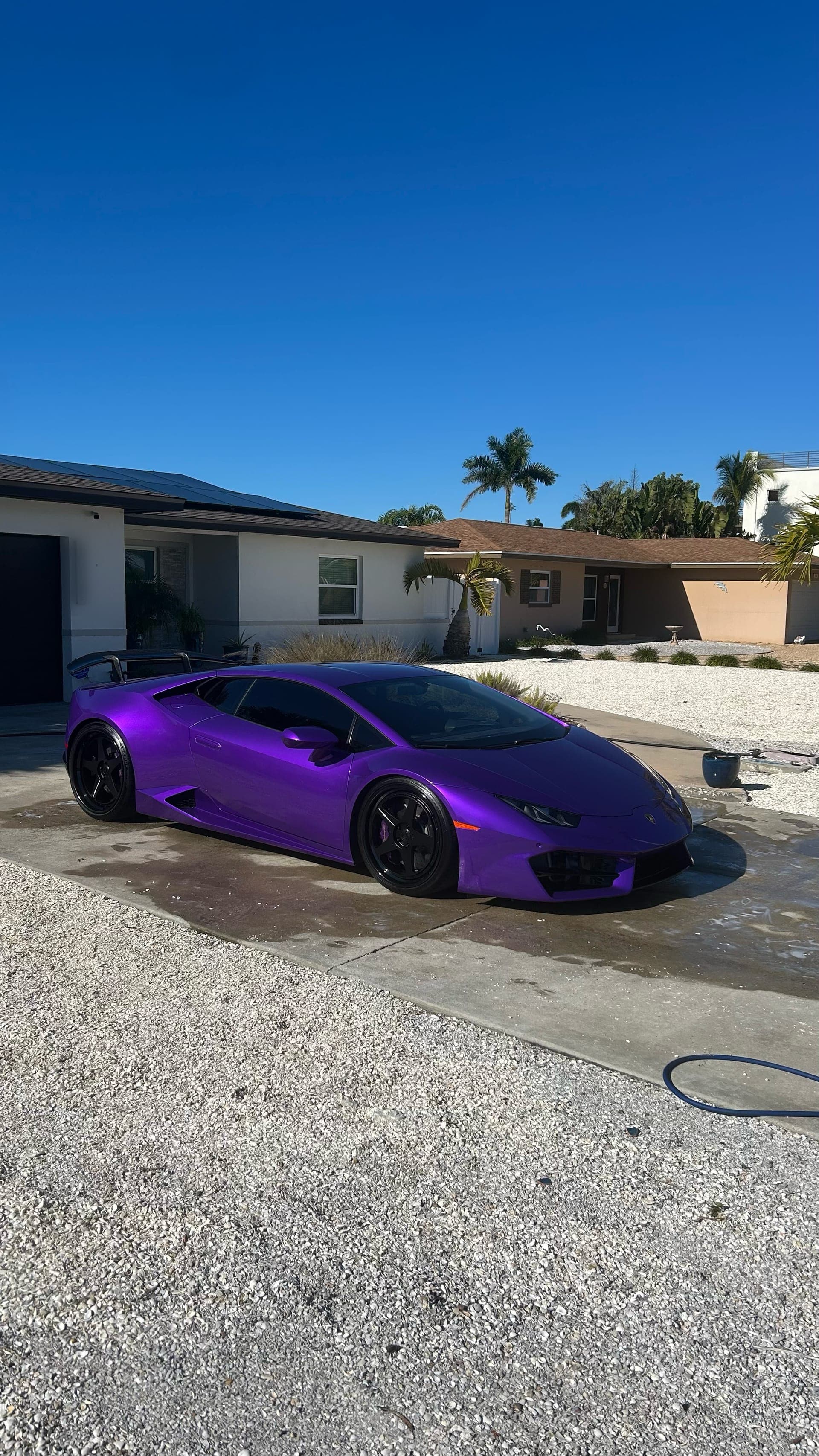 Purple Lamborghini Huracán after mobile detailing under a Florida sky